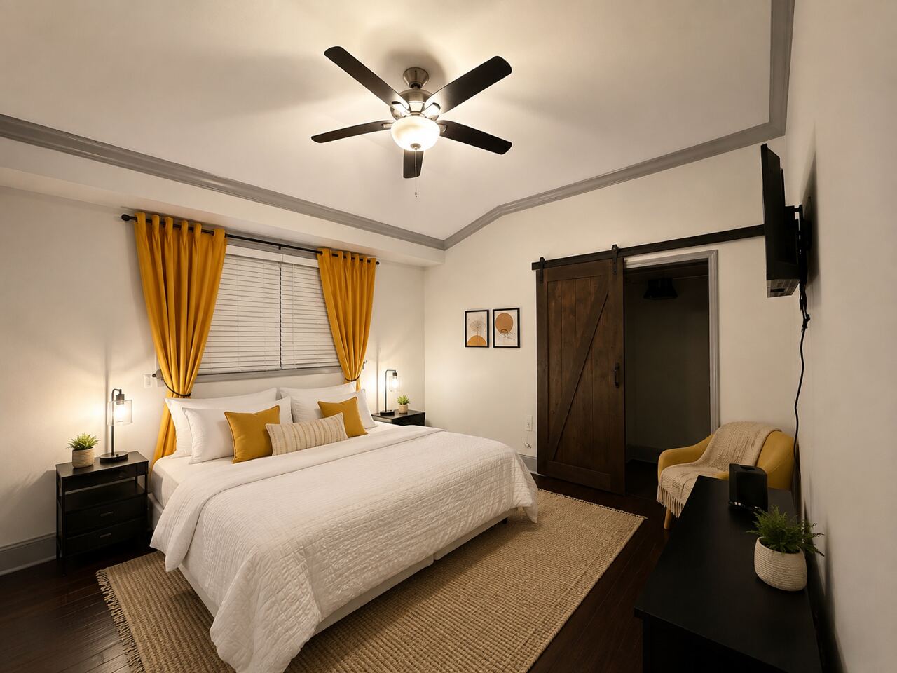 A furnished private bedroom with a queen bed, ceiling fan and warm curtains