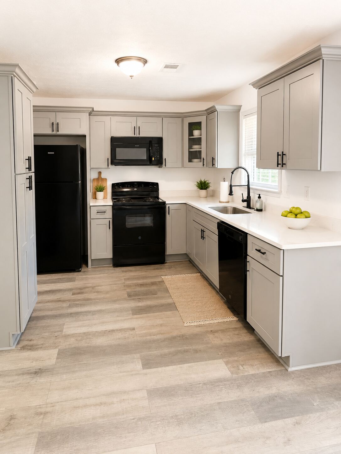 The shared kitchen with white cabinetry and appliances